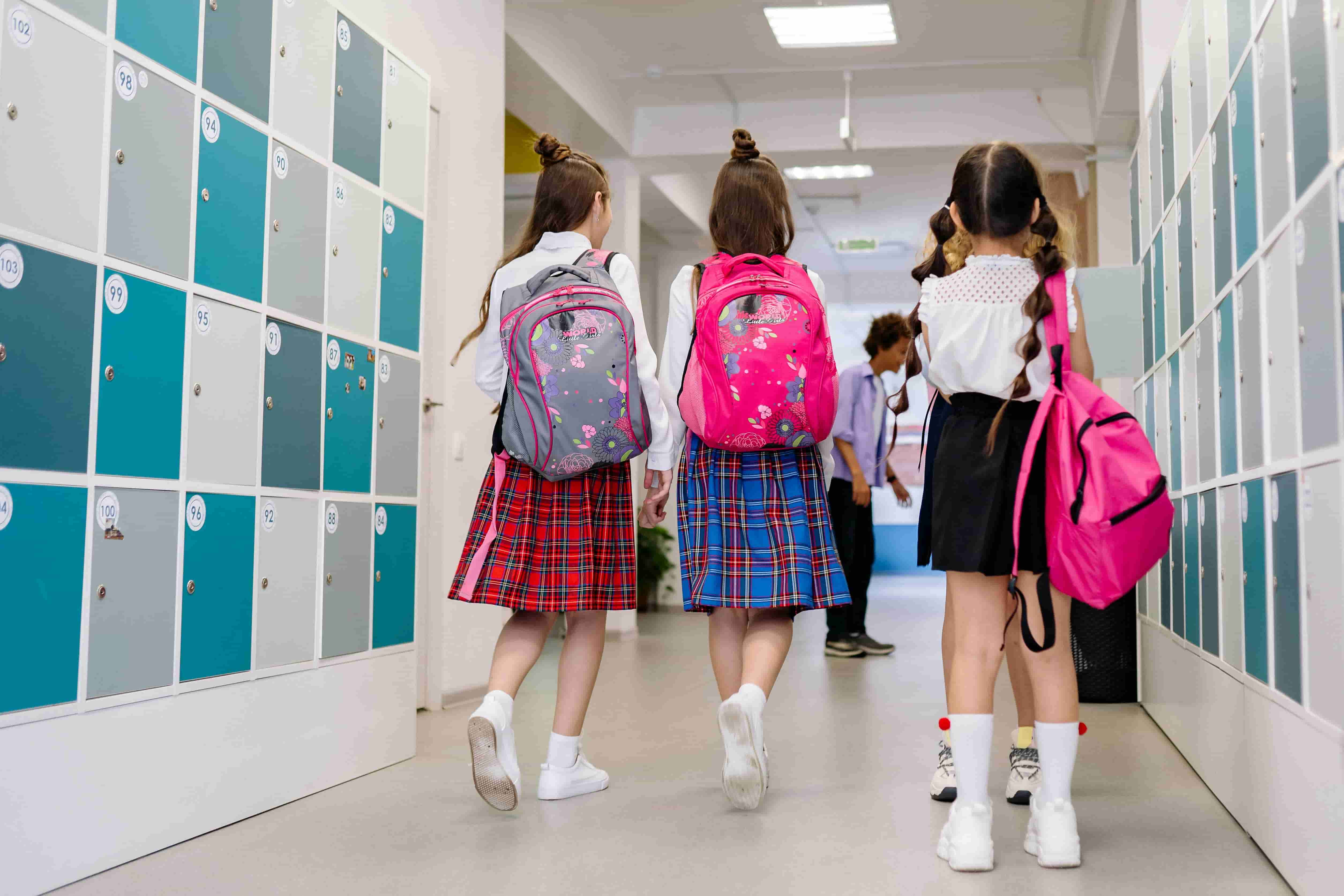 Students walking through a locker corridor